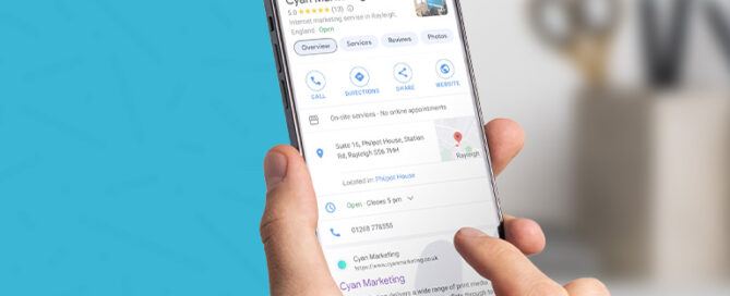 hands holding phone showing Cyan Marketing google profile